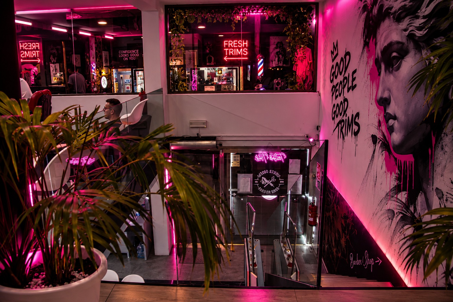 Refresh studio entrance with pink neon signage and staircase in San Antonio, Ibiza